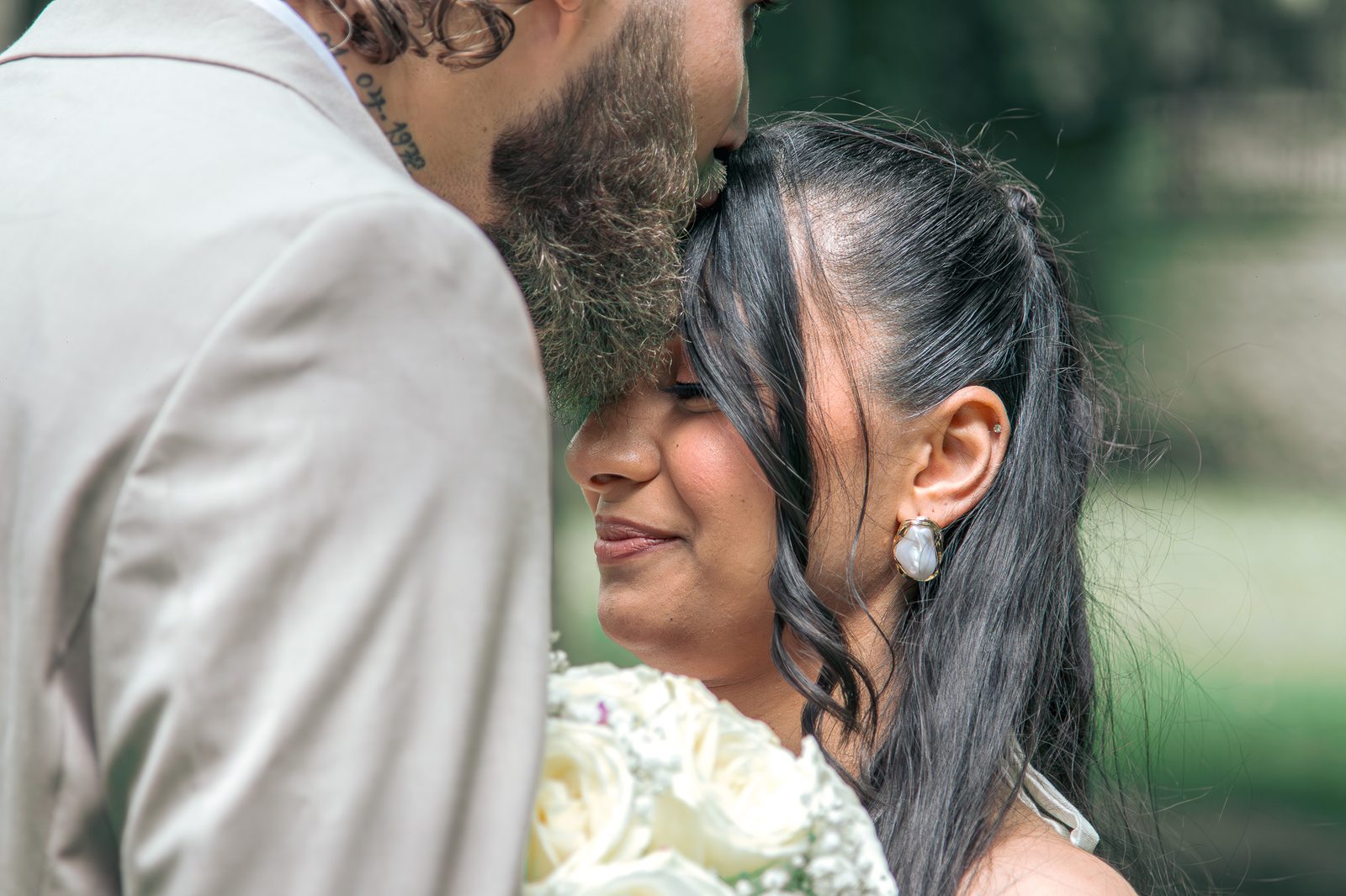 Le marié embrasse le front de la mariée