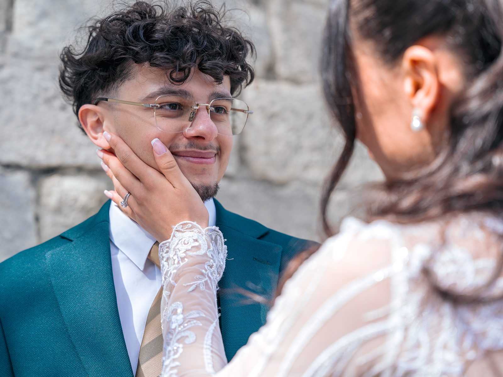 La mariée pose sa main baguée sur la joue du marié